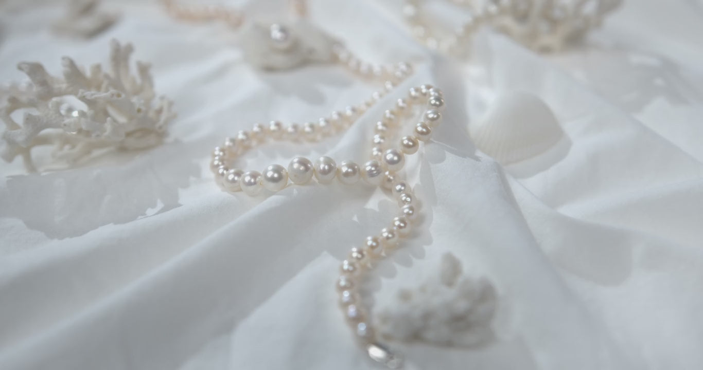 Beadsofcambay White Pearl Necklace on a White Fabric