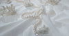 Beadsofcambay White Pearl Necklace on a White Fabric