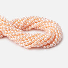 7x5mm Peach Straight Drill Oval Freshwater Pearl 15 inch 56 pcs - BeadsofCambay.com